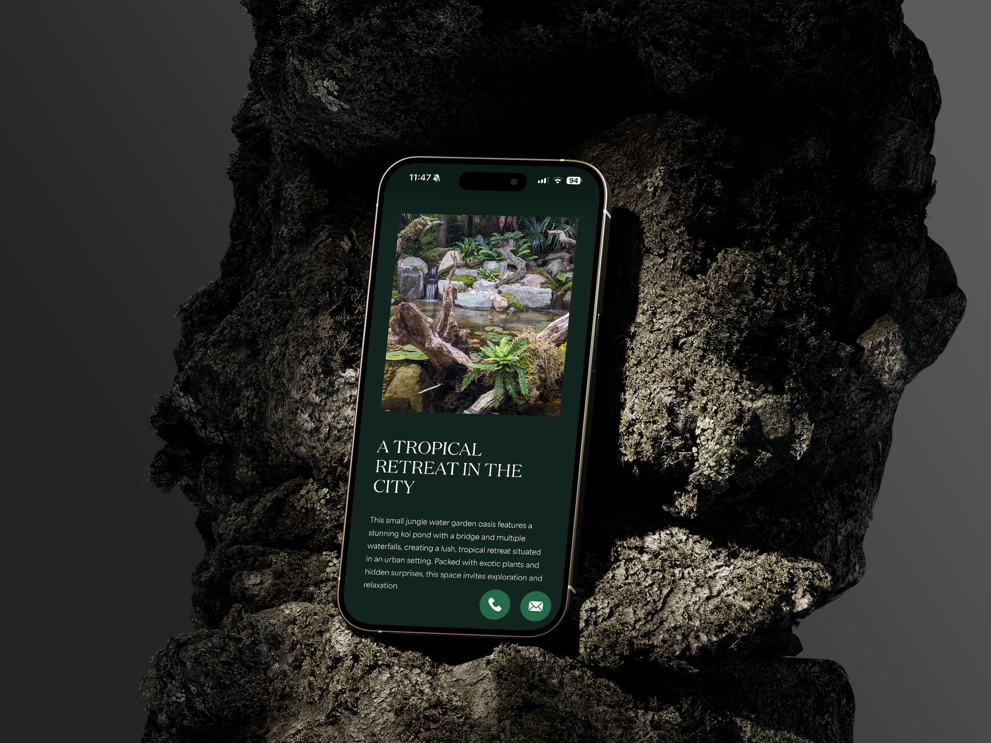 A smartphone displays an article titled “A Tropical Retreat in the City” with an image of a lush garden, resting on a textured rock.